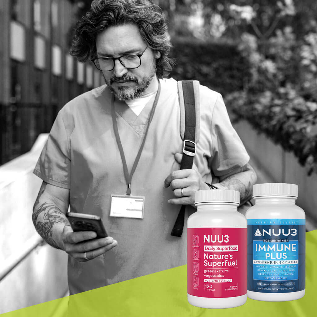 Man looking at phone with two NUU3 supplement bottles on a green surface