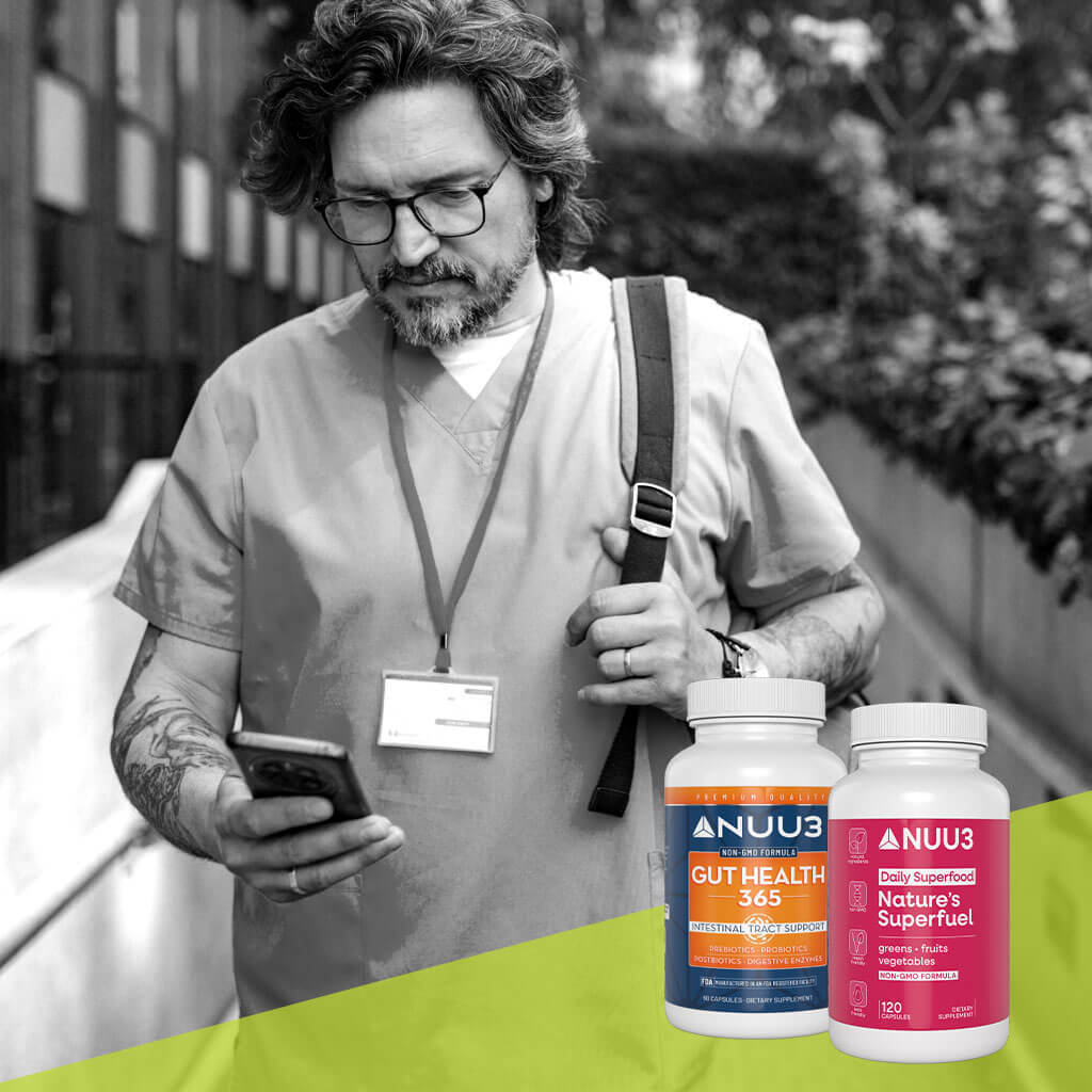 Man looking at phone with two NUU3 supplement bottles on a green surface