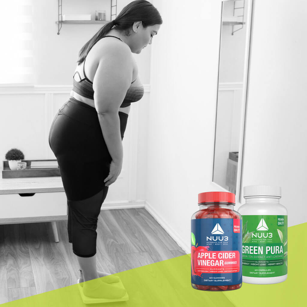 Person standing in front of a mirror with two supplement bottles labeled 'NUU3 Apple Cider Vinegar'