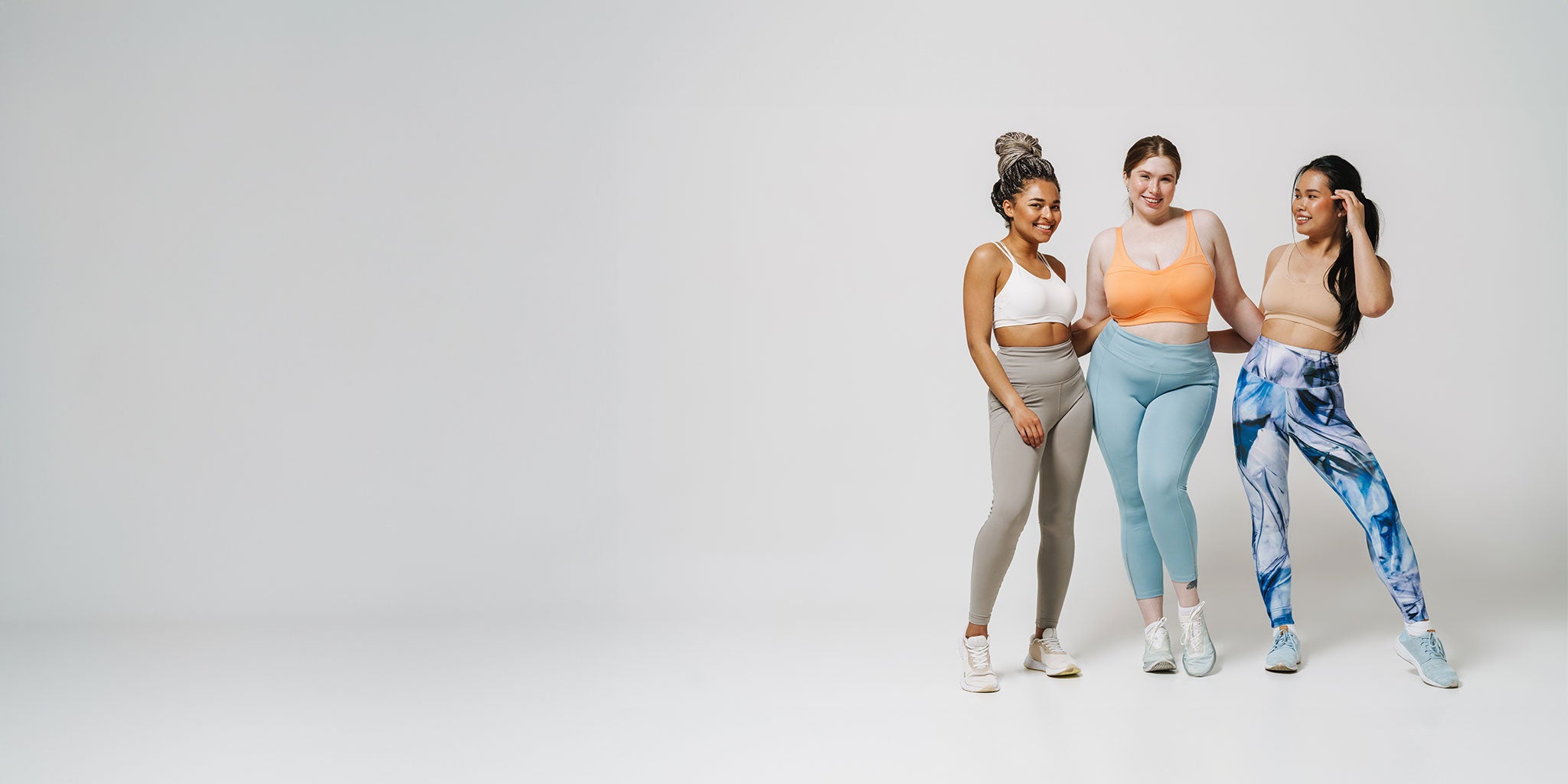 3 ladies in gym wear looking happy