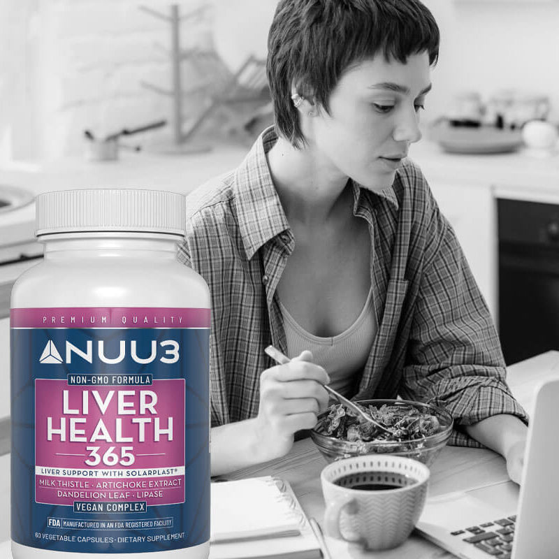 Woman eating at a kitchen table with a Nuu3 supplement bottle in the foreground