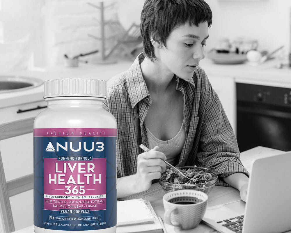 Woman eating at a kitchen table with a Nuu3 supplement bottle in the foreground